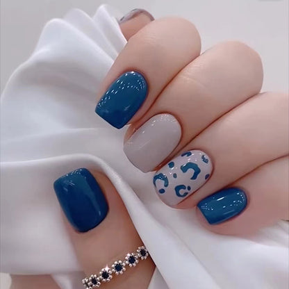 Blue Panther nails featuring a striking leopard print pattern in shades of blue, paired with solid blue nails for a bold contrast.