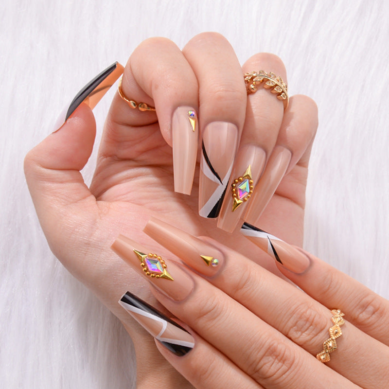 Coffin-shaped nails adorned with sparkling rhinestones, creating a glamorous and eye-catching design that adds elegance to any look.