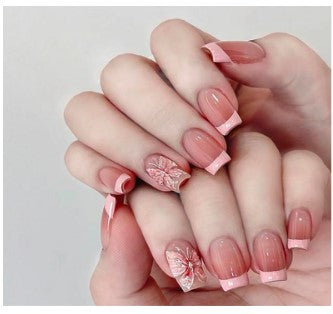 French Butterfly nails featuring a classic French tip design with delicate butterfly accents, combining elegance with a whimsical touch.