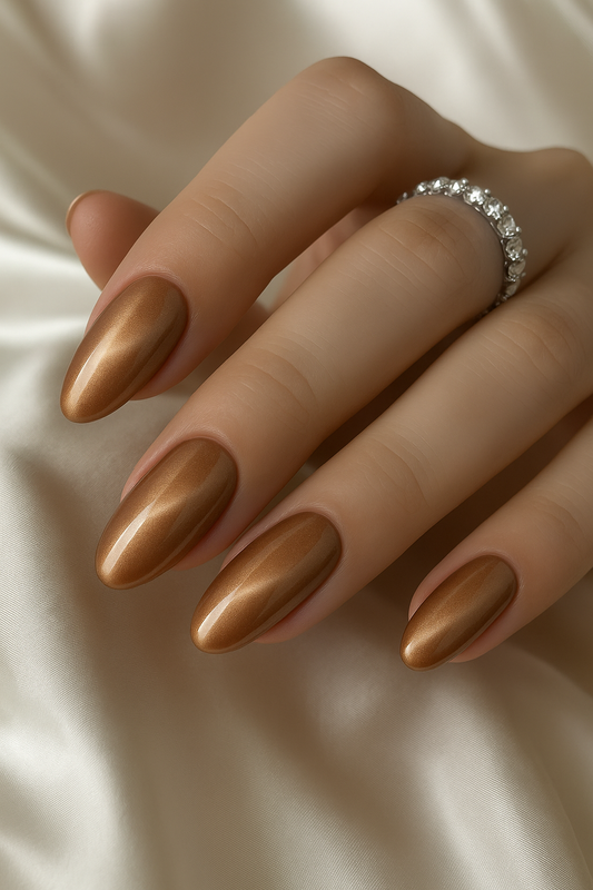 Glossy bronze metallic oval press-on nails set by Elanto Nails on white background