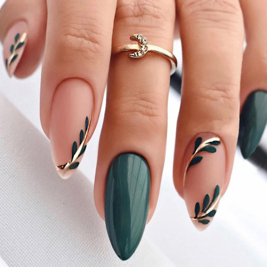 Green Leaf nails featuring a solid beige base with intricate green leaf patterns on some nails, complemented by a few nails in a vibrant solid green.