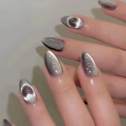 "Elegant Grey Heart Coffin nails with a captivating cat eye shimmer."