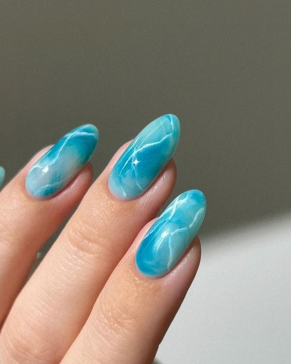 Marble blue nails featuring soft swirls of blue and white, creating a calming and elegant marbled effect.