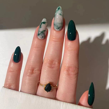 Marble green nails featuring a mix of emerald and white swirls, creating a luxurious and nature-inspired marbled effect.

