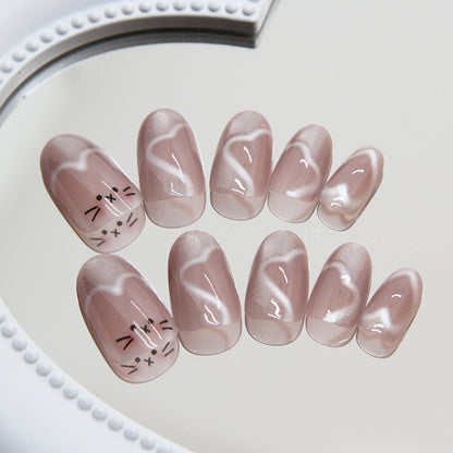 Skin-tone Meow Manicure nails with a cat eye effect, blending a natural hue with a refined shimmer for a sophisticated and stylish appearance.