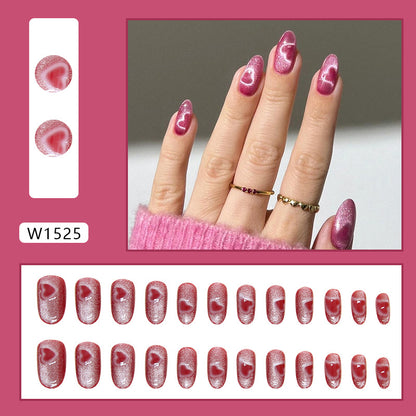 Stunning Pink Heart nails adorned with a cat eye design, showcasing a unique blend of pink tones that create a heart-like glow.