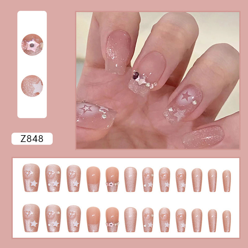 Pink Stardust nails showcasing a blend of pastel pink and glittery accents, creating a magical and festive appearance.