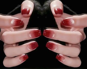 Elegant red ballet nails featuring a stunning gold ombre effect, transitioning smoothly from rich red to shimmering gold tips.