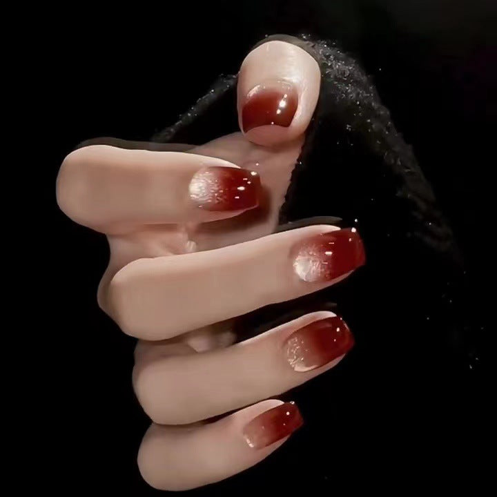 Red ballet nails with a gradient of deep red blending into a soft gold ombre, creating a sophisticated and eye-catching design.