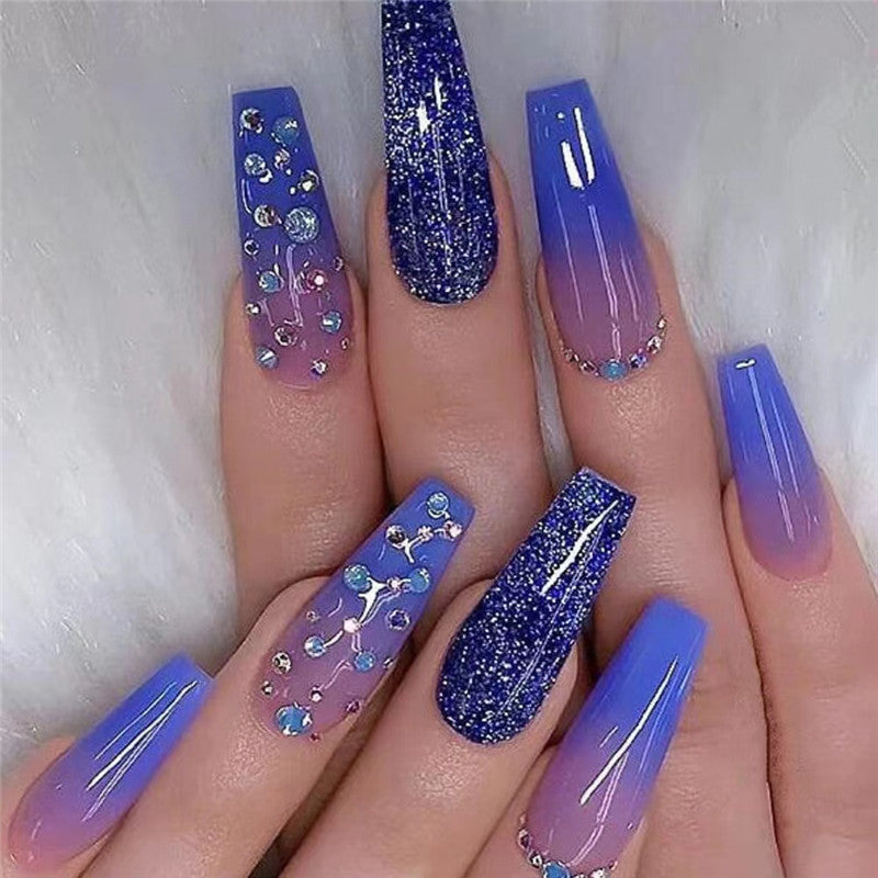 Rhinestone Blue nails featuring a vibrant blue base adorned with sparkling rhinestones, creating a glamorous and eye-catching design.