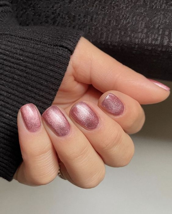 Glossy Merlot Cat Eye nails in a luxurious wine shade, with a shimmering cat eye finish that catches the light beautifully.






