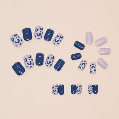 Blue Panther nails featuring bold leopard print designs on select nails, alongside solid blue nails for a stylish ensemble.